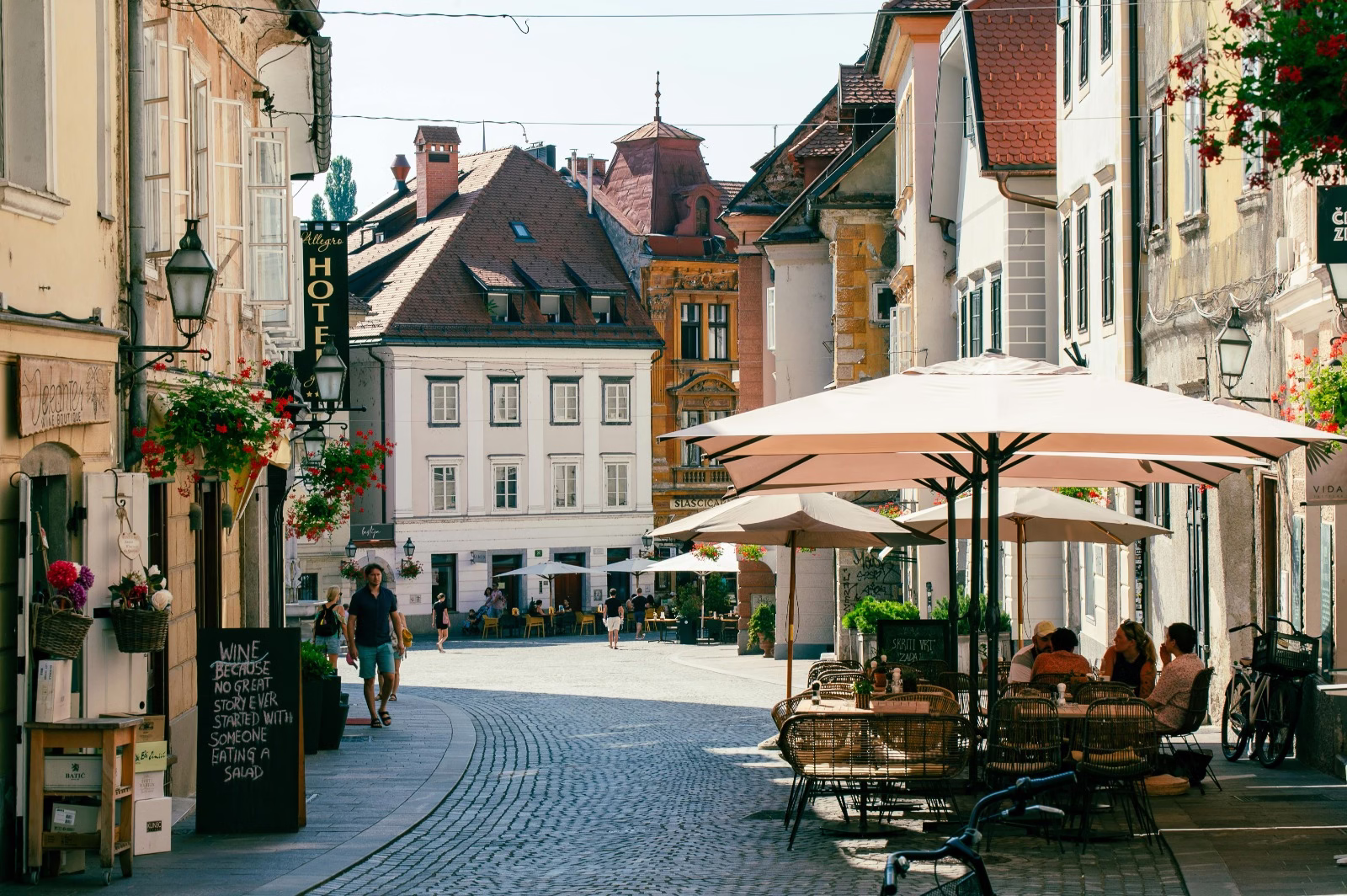 Cobblestone street in Europe with outdoor lunch tables